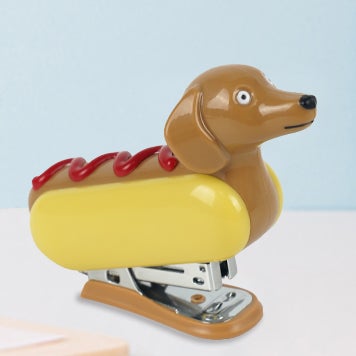 a mini stapler shaped like a dachshund hot dog