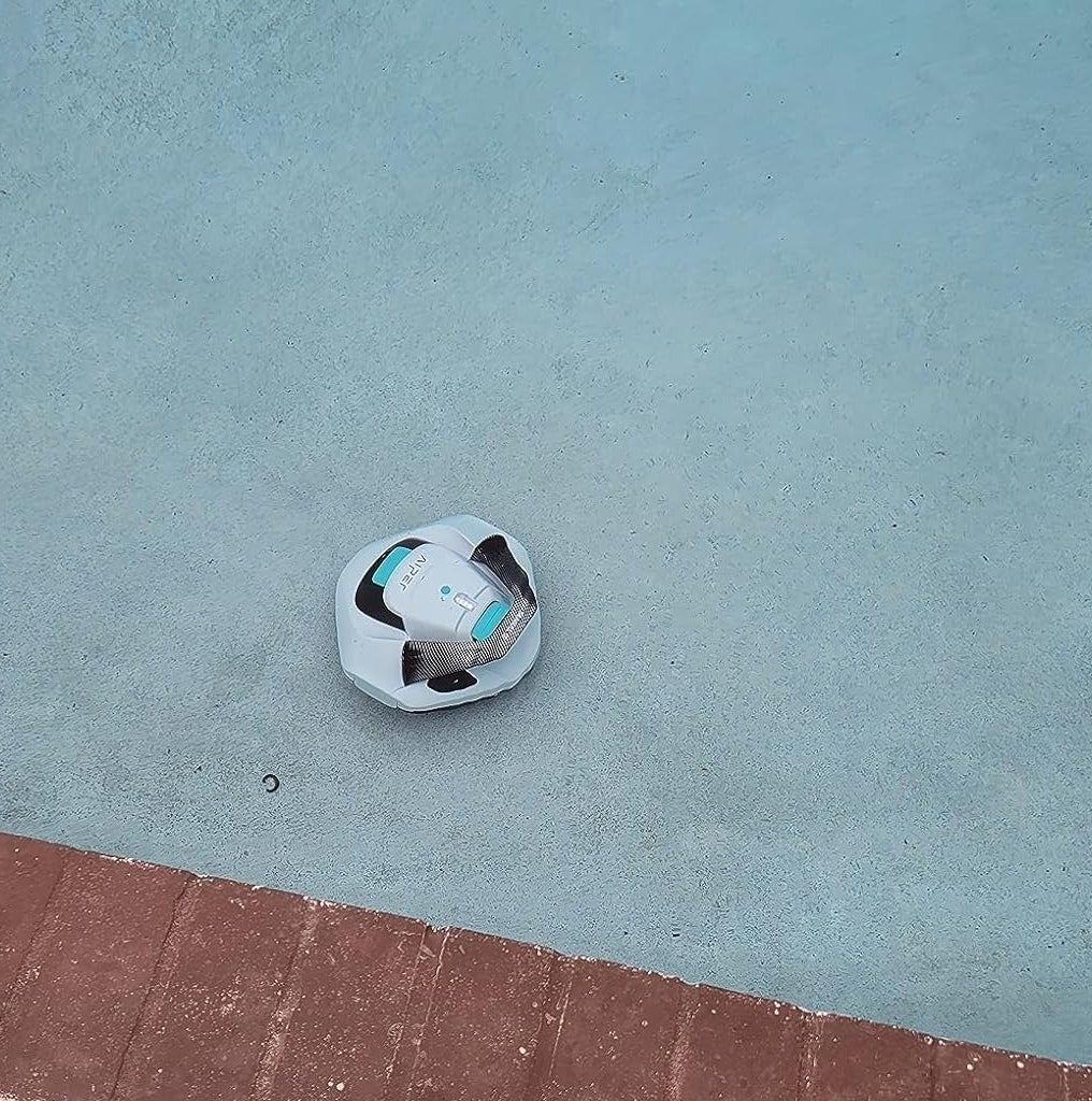 reviewer image of the robotic pool cleaner at the bottom of a pool