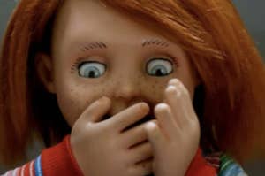 Chucky the doll with brows raised, mouth covered by his hand