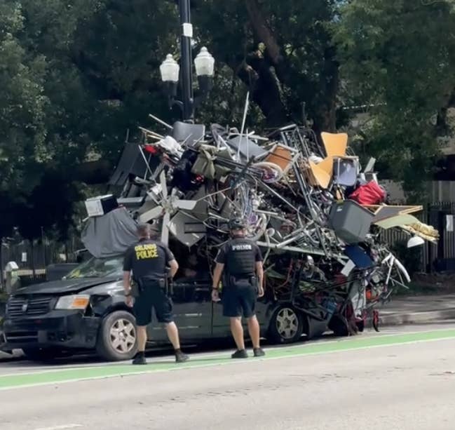 a pickup truck stacked with household furniture and items that are weighing the truck down