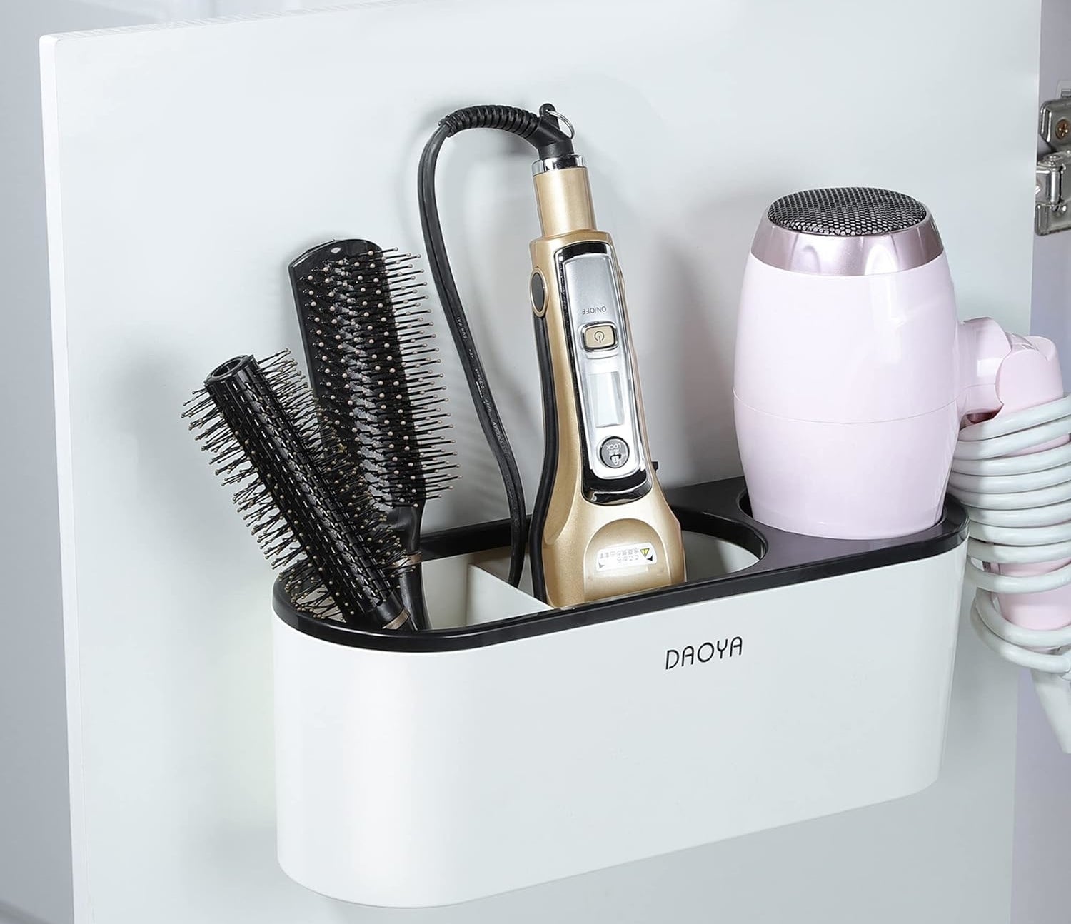 organizer holding hair brushes, a flat iron, and a hair dryer