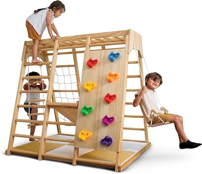 Three kids playing on the play set