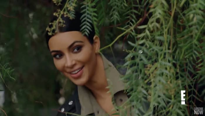 Kim Kardashian peeks out of the bushes