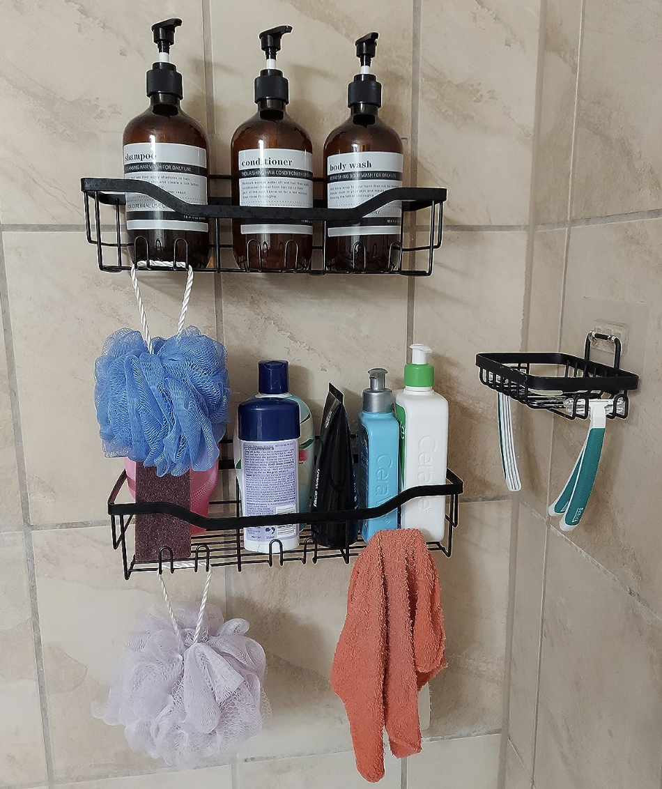 reviewer photo of the shower shelves in their shower holding various shower products