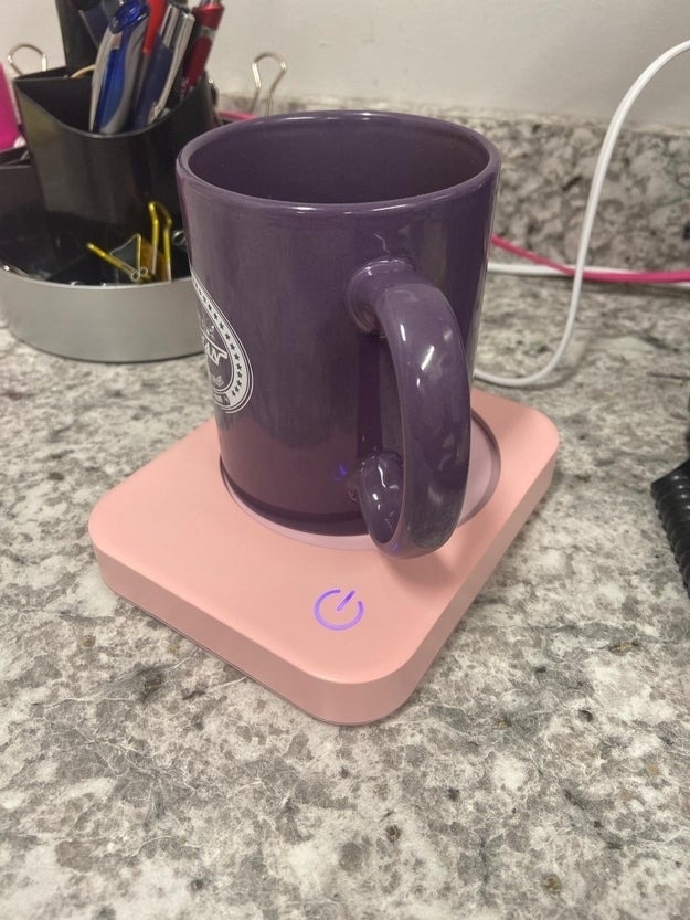 pink mug warmer with purple mug on desk