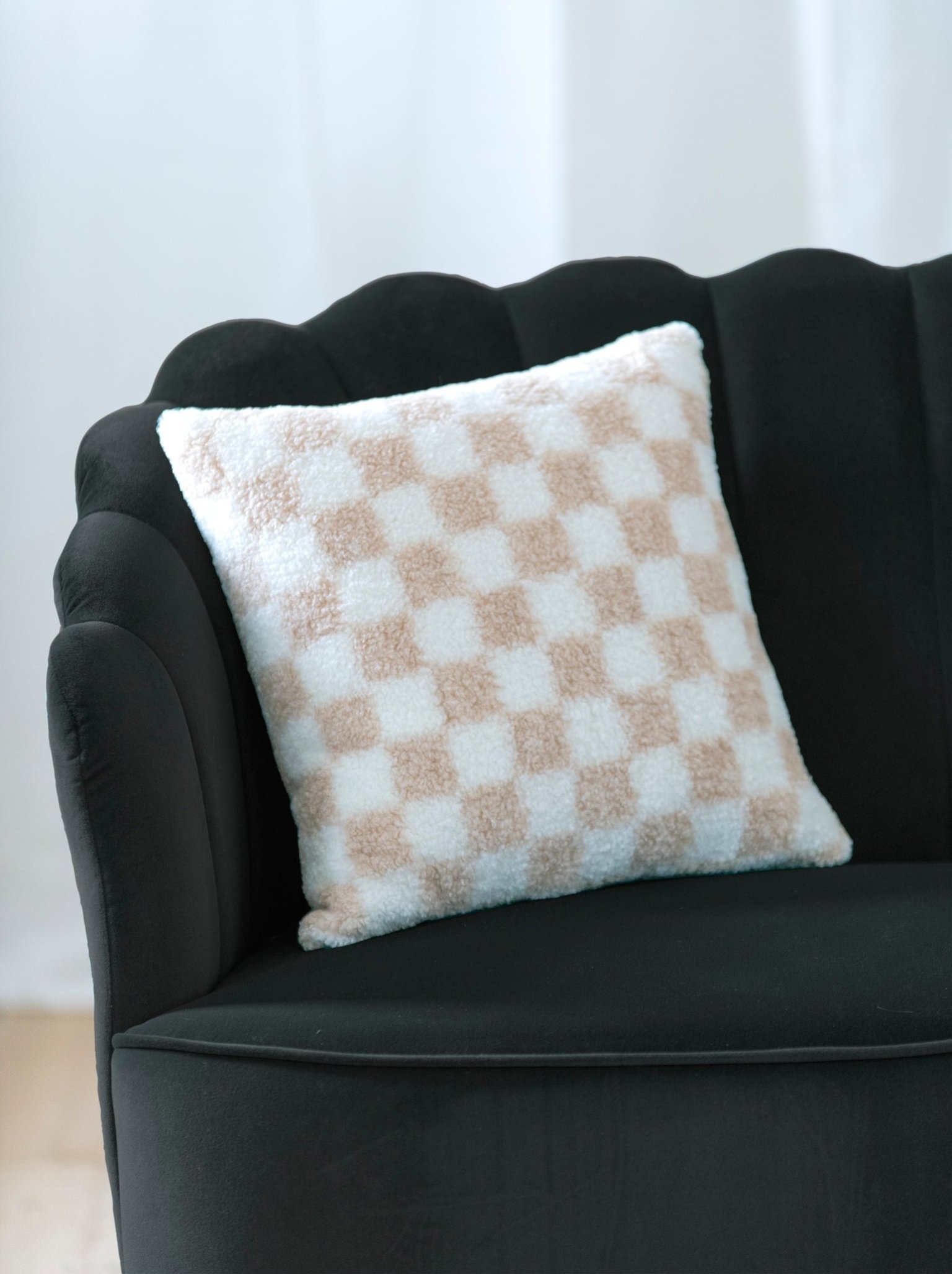 the checkered throw pillow in tan and white