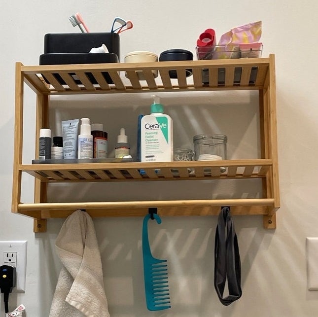 reviewer image of the accent shelf with bathroom toiletries on it