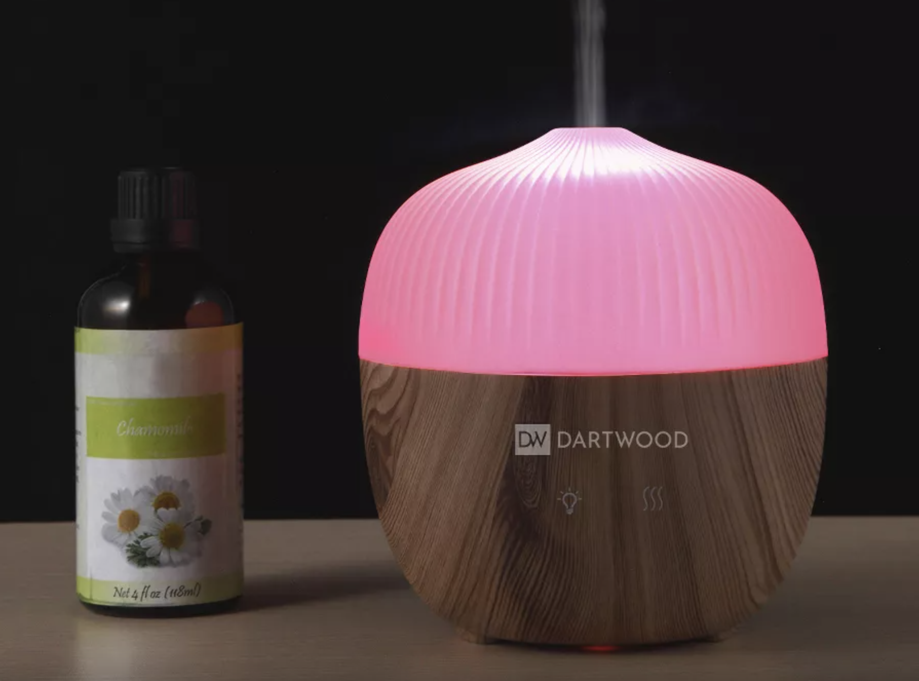 the pink diffuser next to a bottle of essential oil