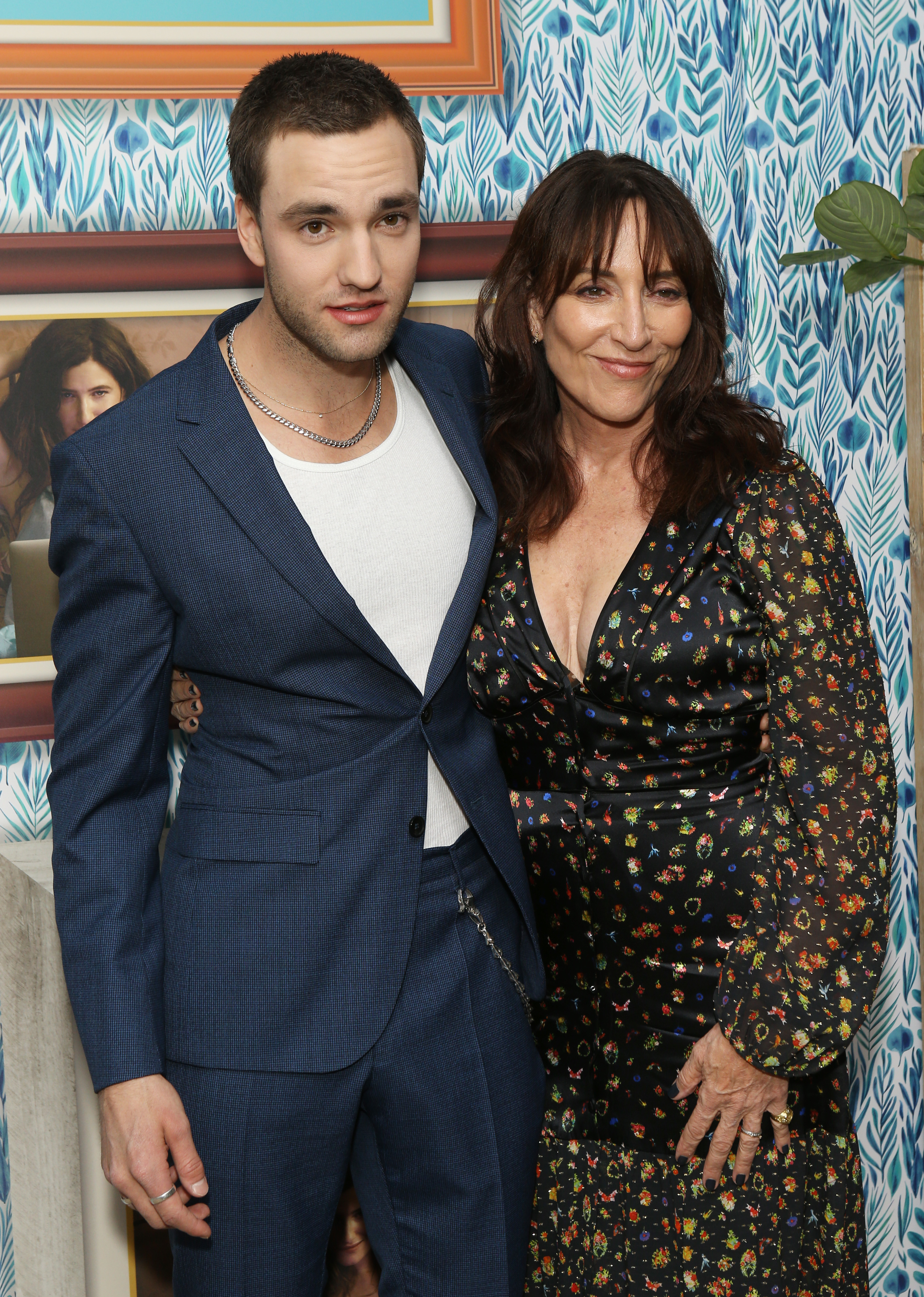 her arm around her son at an event