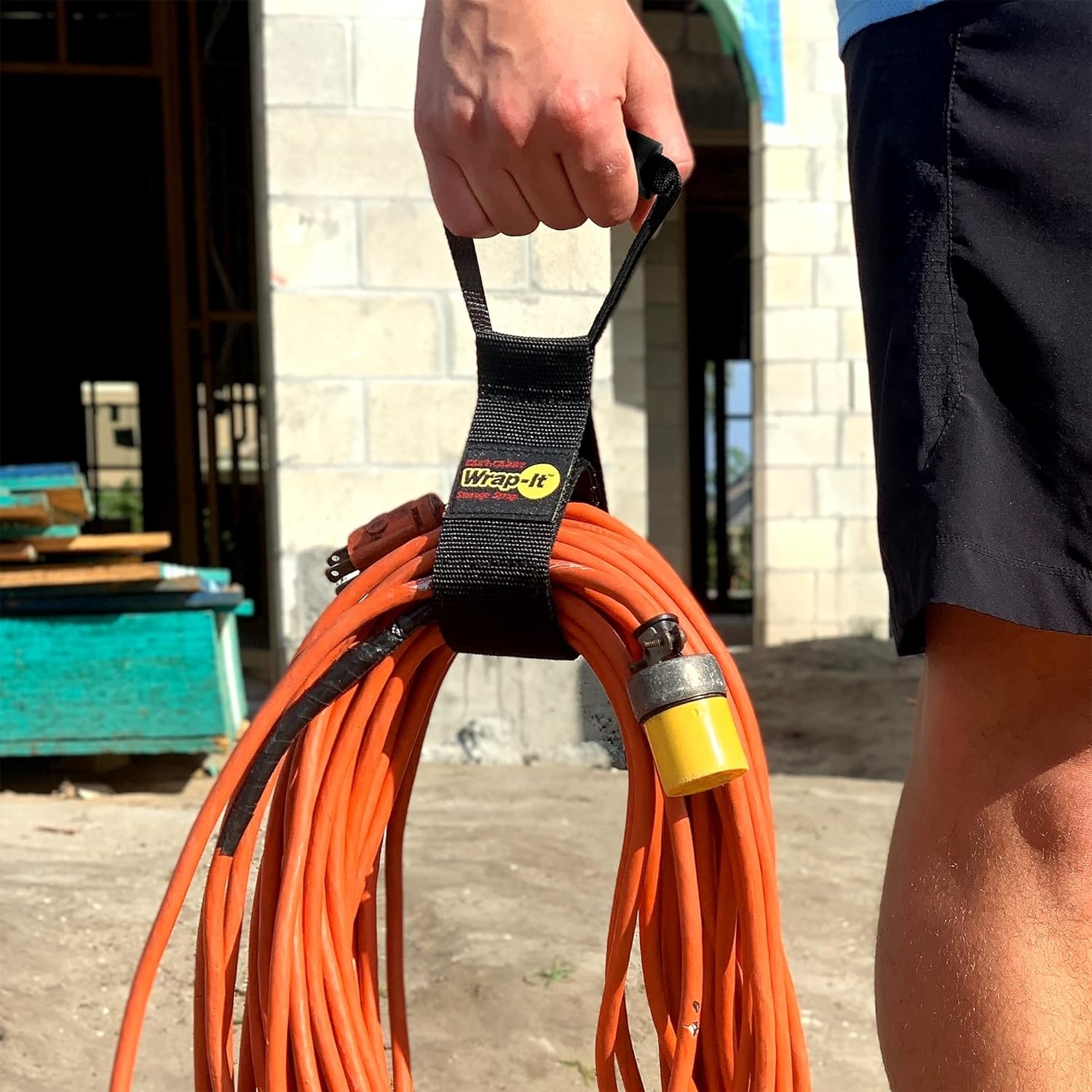 person carrying hose with the strap attached