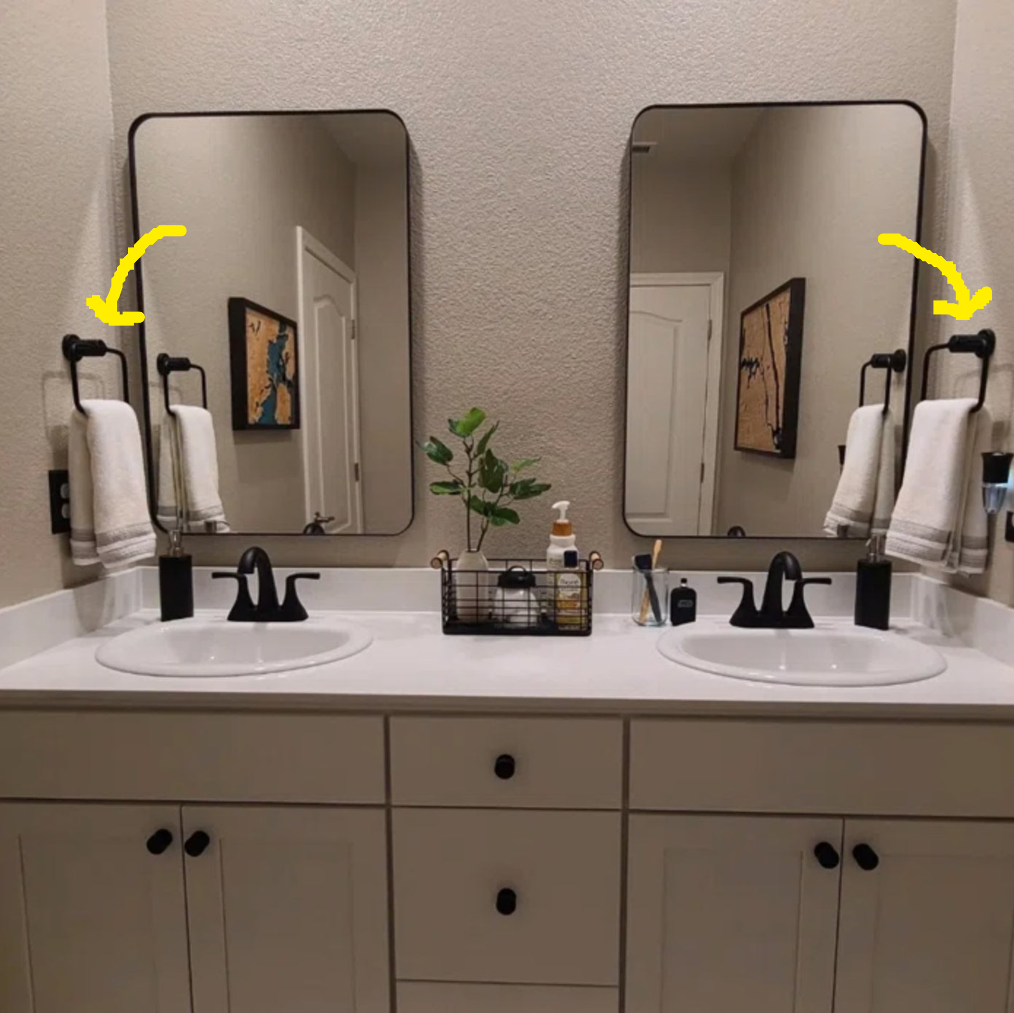 a double vanity with four square towel rings