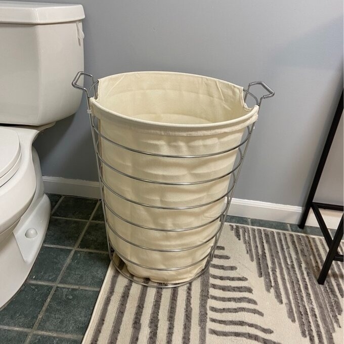 reviewer image of the laundry hamper in their bathroom
