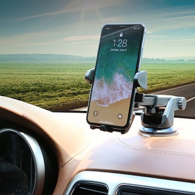 A phone mounted on a dashboard