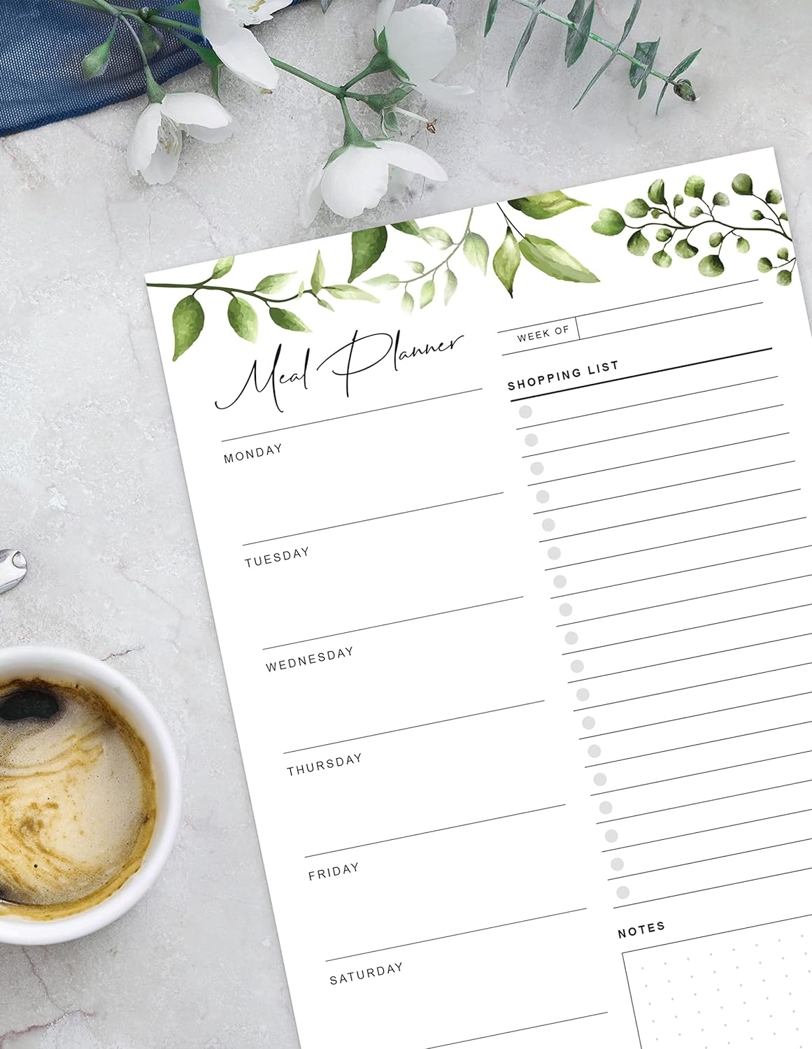 the meal planning pad next to a mug of coffee