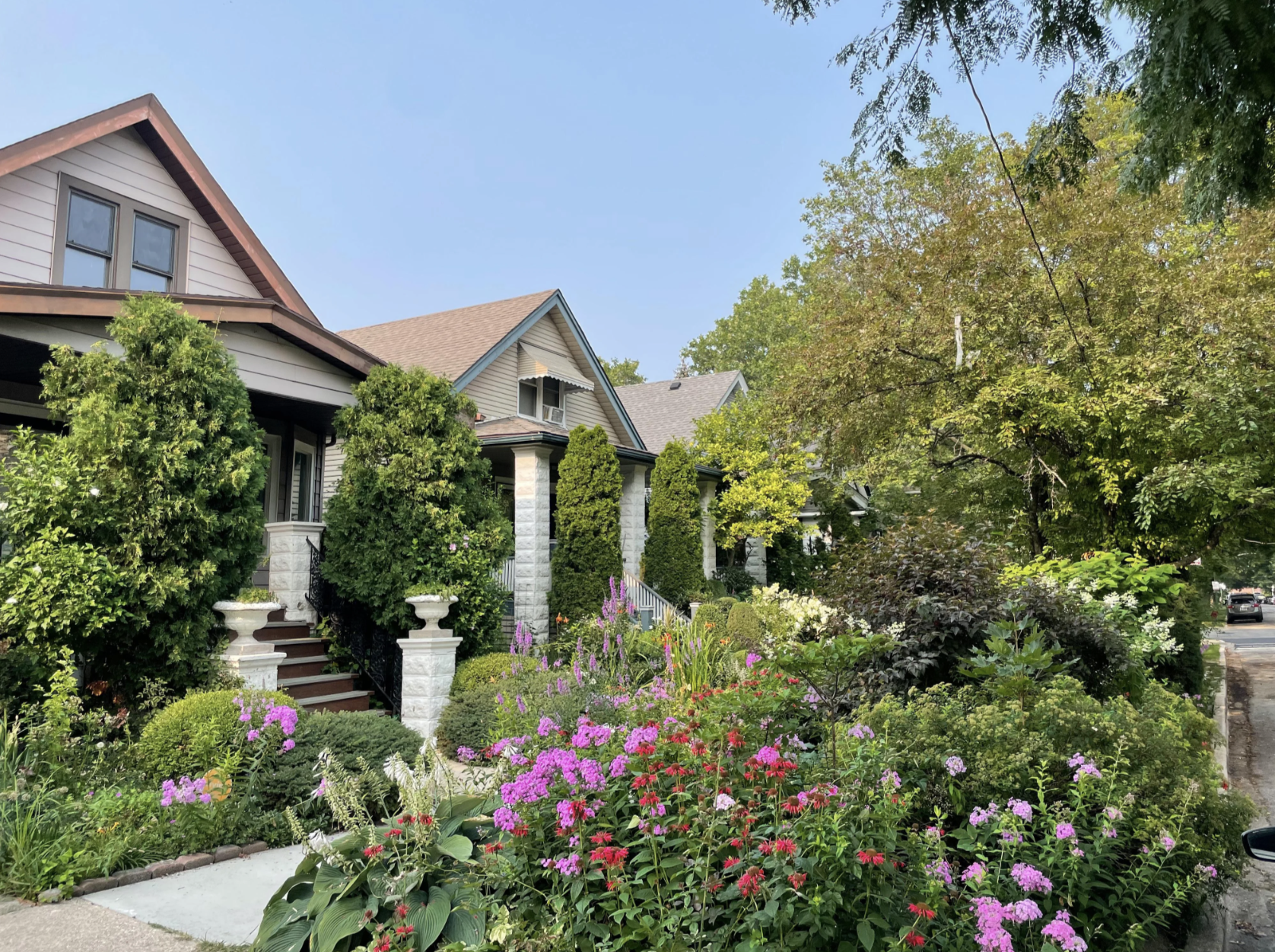 Houses with lush yards and lots of flowers