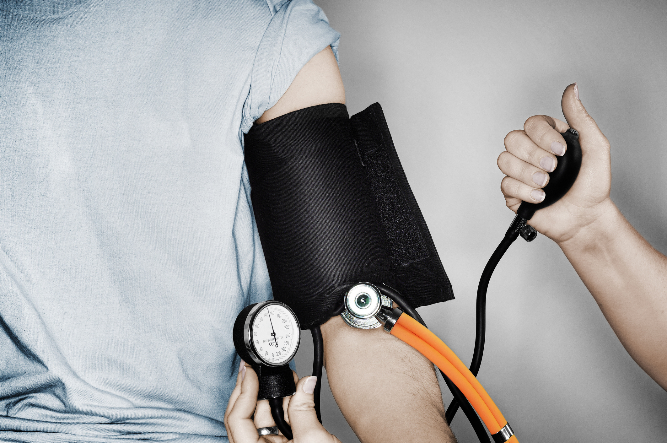 person&#x27;s arm wrapped in a blood pressure tester