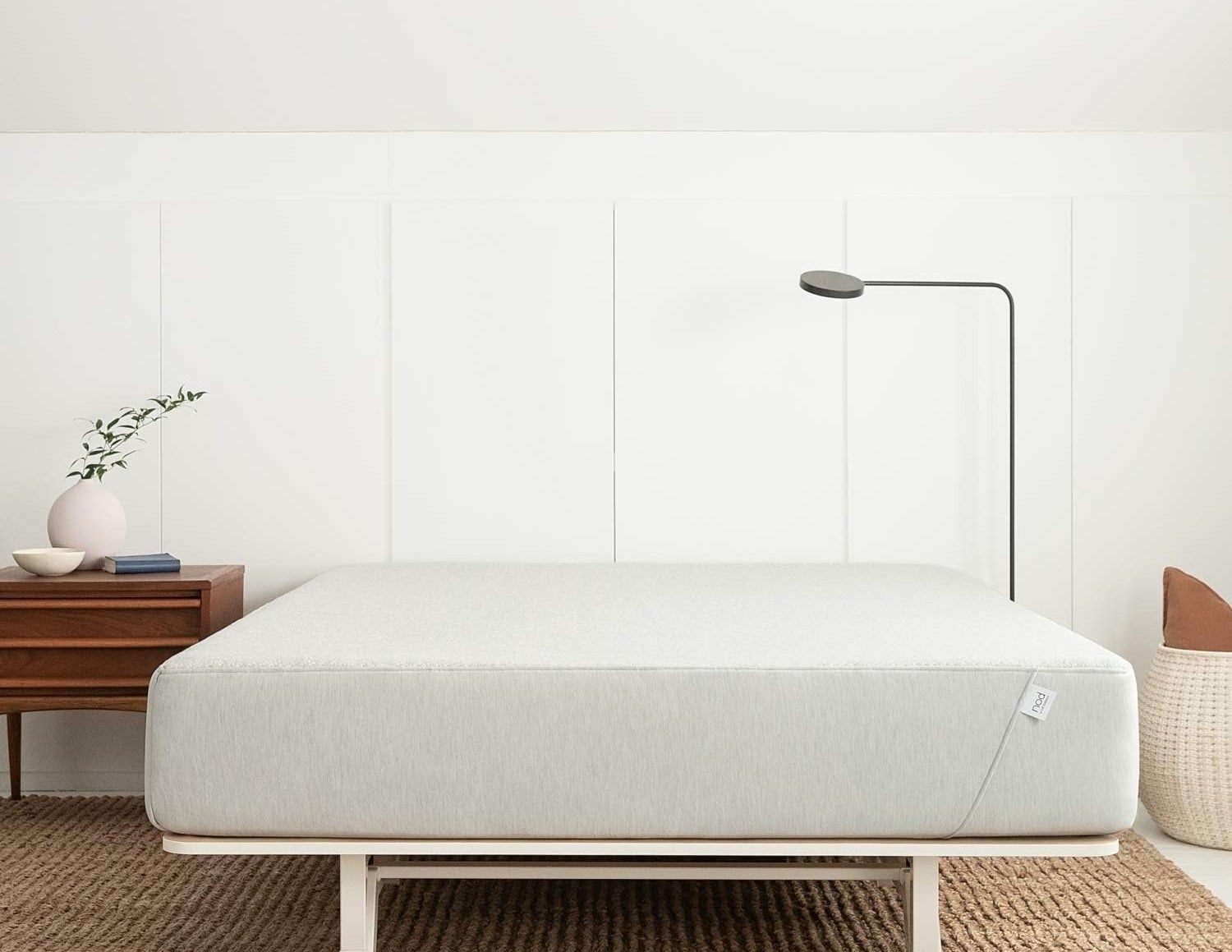 the queen hybrid mattress on a white bed frame
