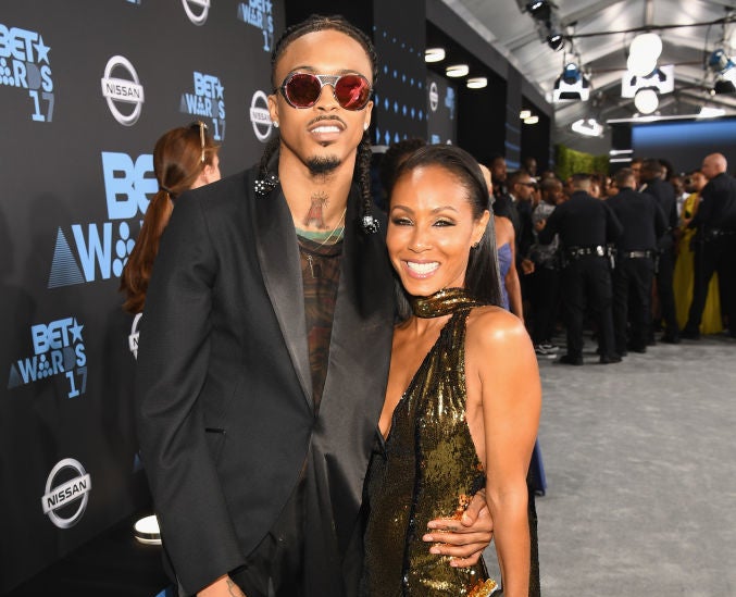 closeup of August with his arm around Jada at the BET awards