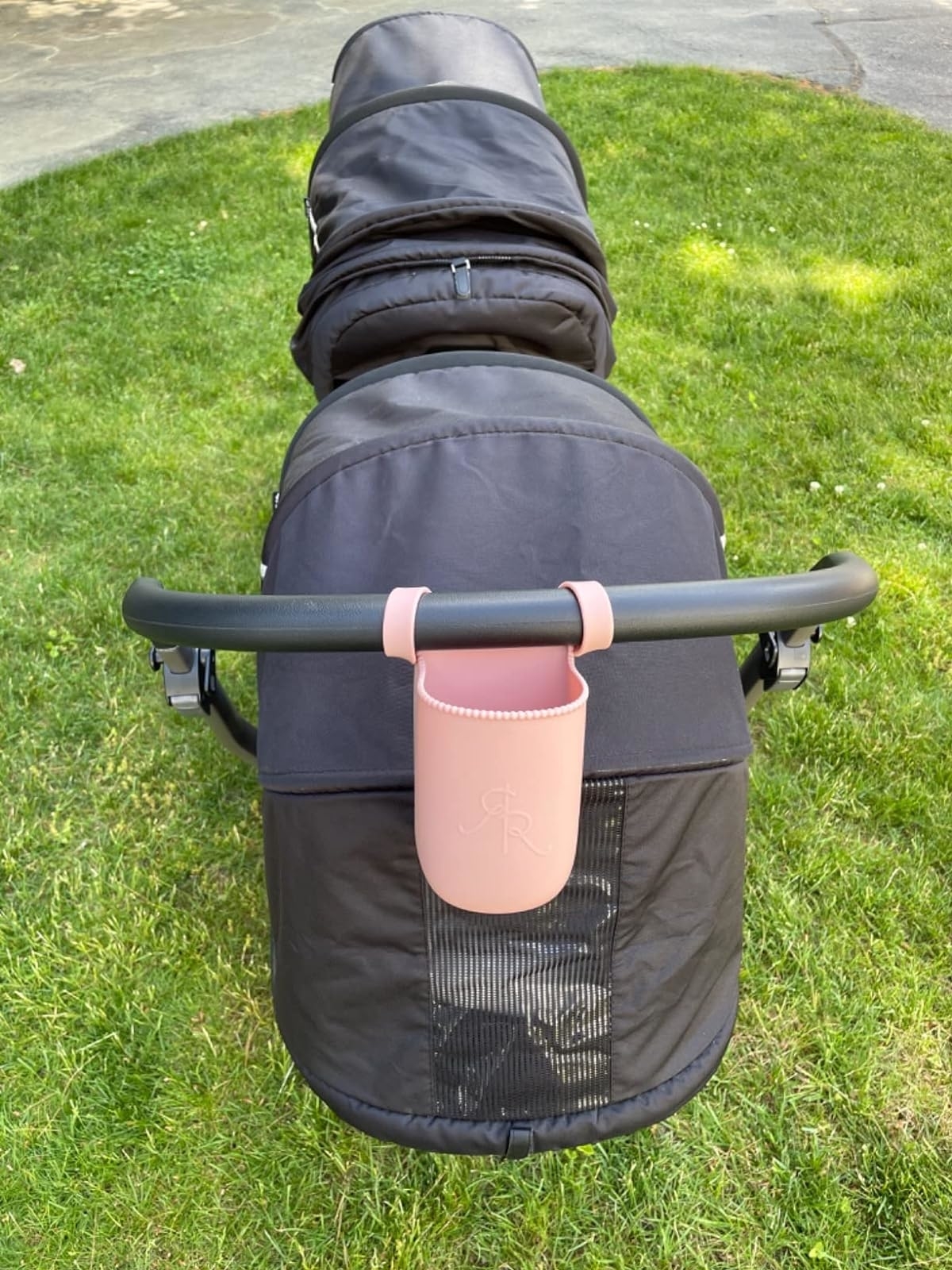 a pink silicone cup holder on a stroller