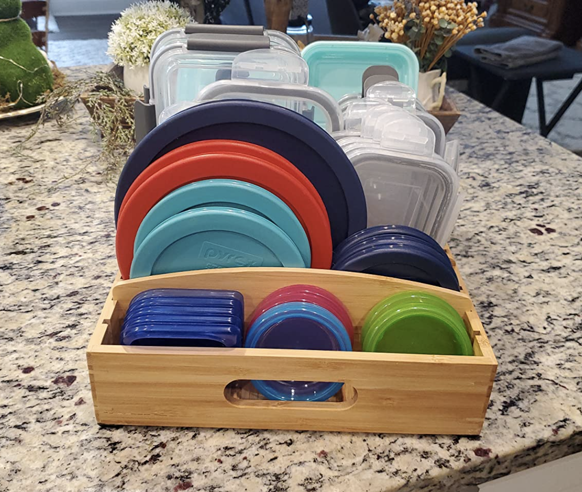reviewer photo of various container lids inside the organizer