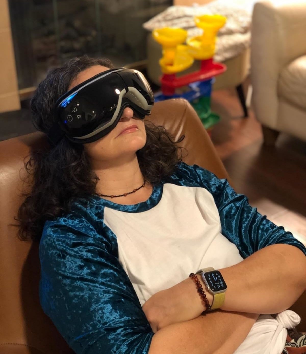 reviewer relaxing with the heated eye massager
