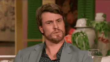 a man reacting in a shocked and cringed way