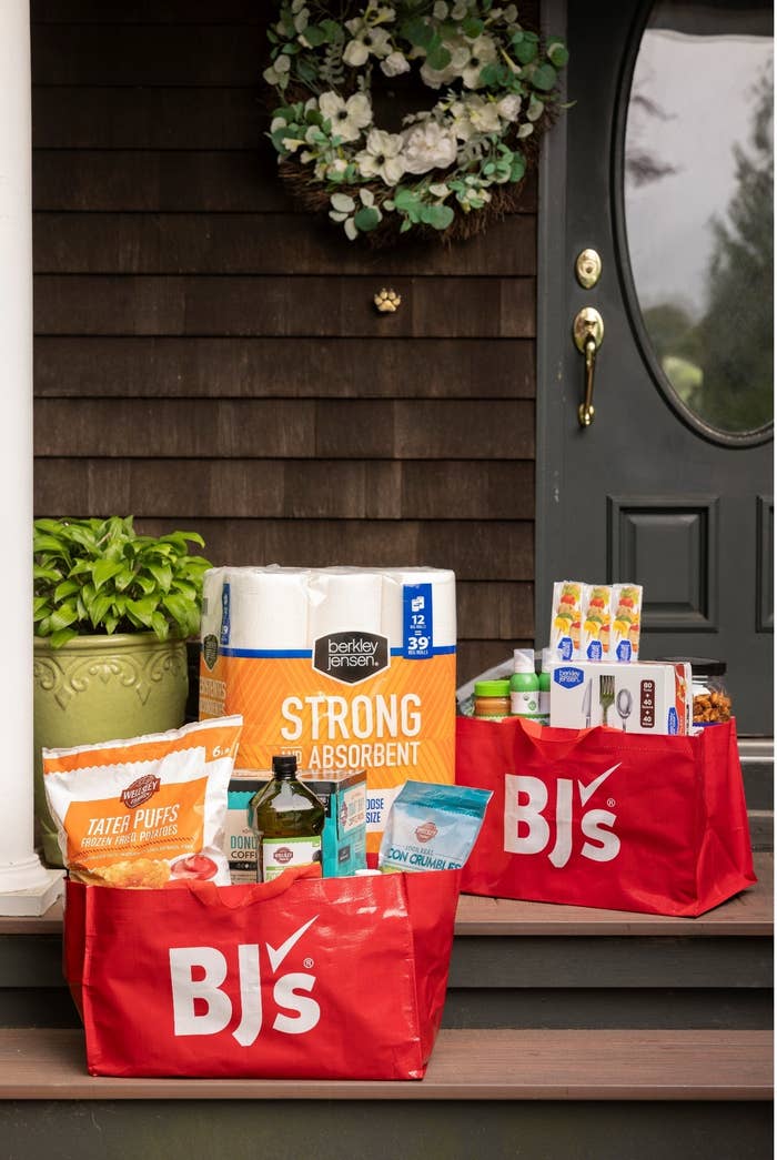 BJ&#x27;s groceries sit in bags on a front porch