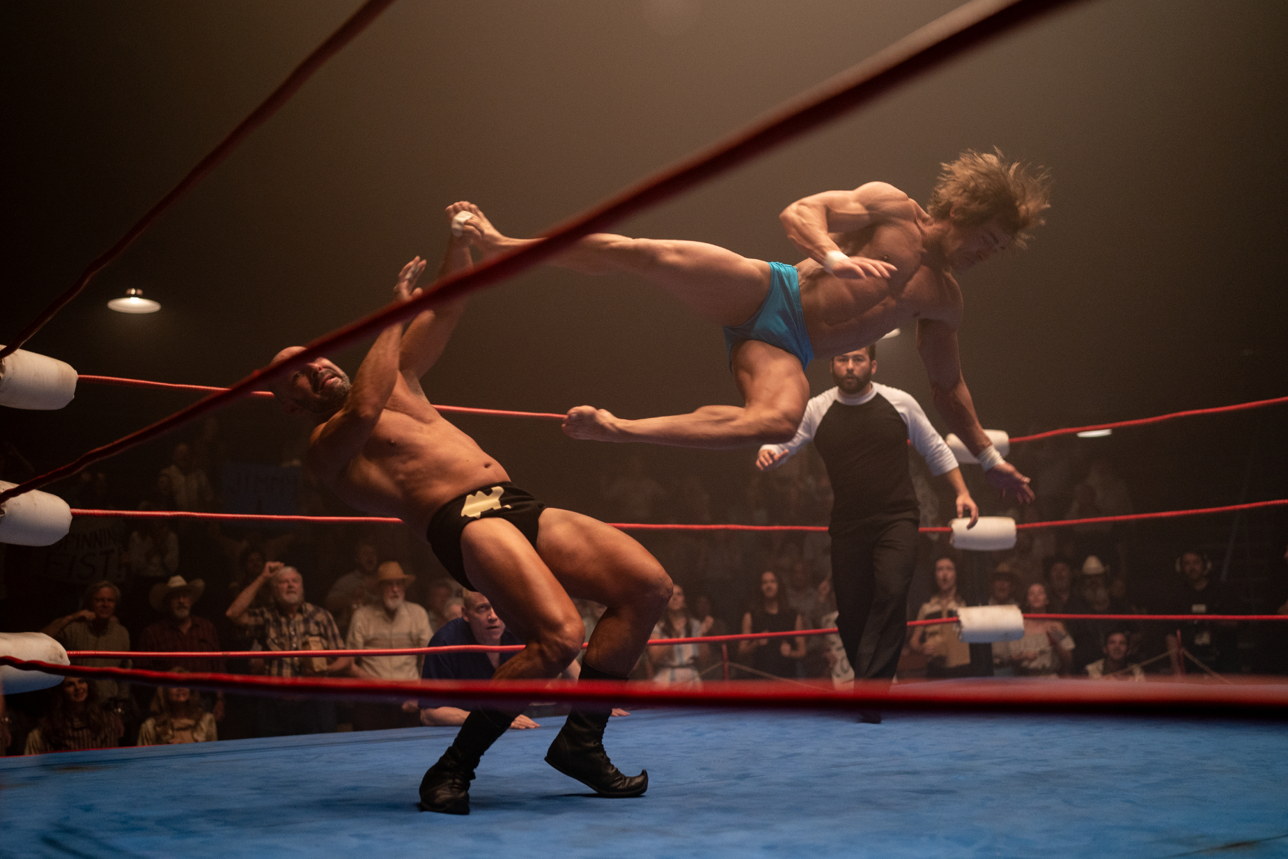 One man jump kicking another in a scene from &quot;The Iron Claw&quot;