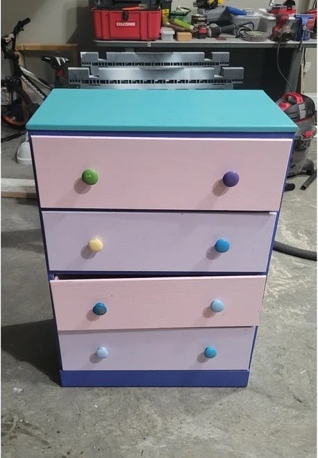 A before image of a colorful dresser with a broken drawer