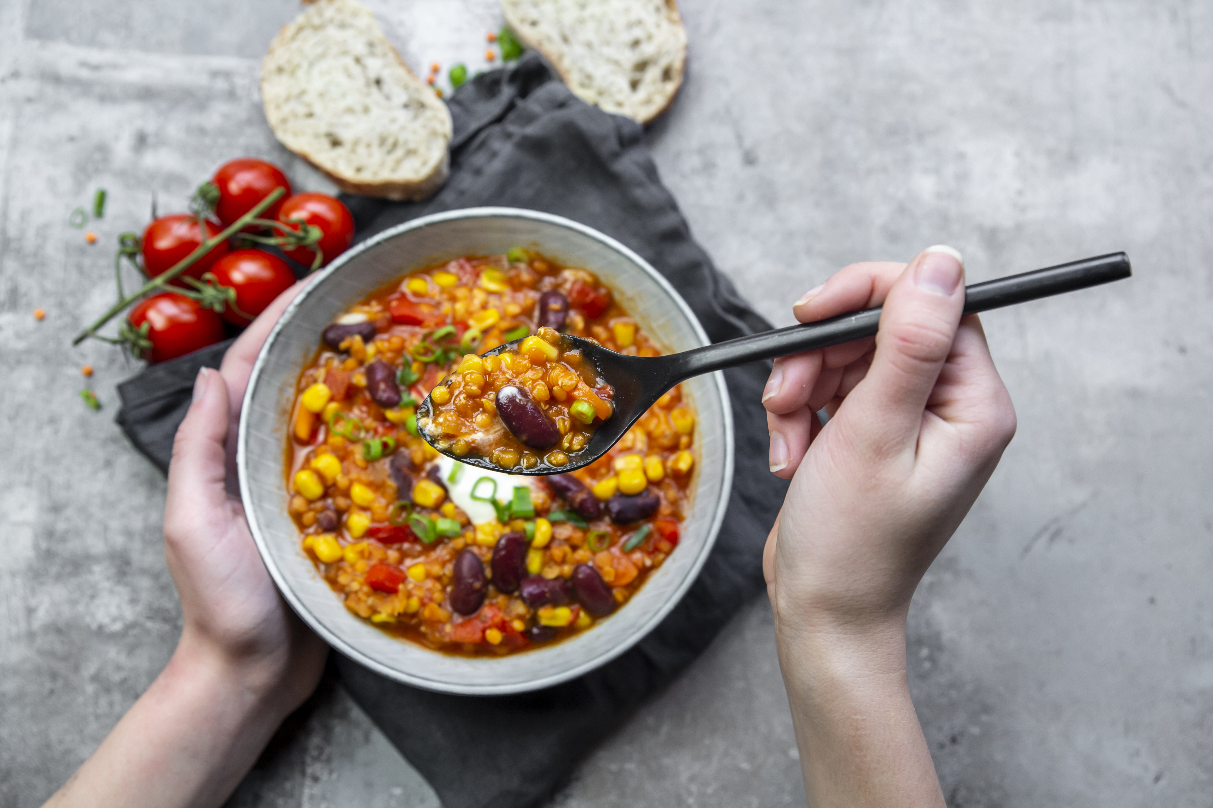 woman eating a bowl of bean stew