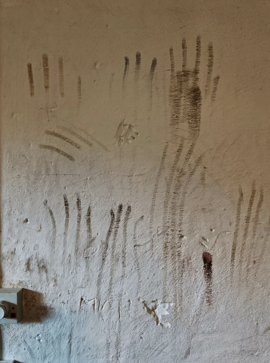 Lines and streaks that look a bit like handprints on a wall