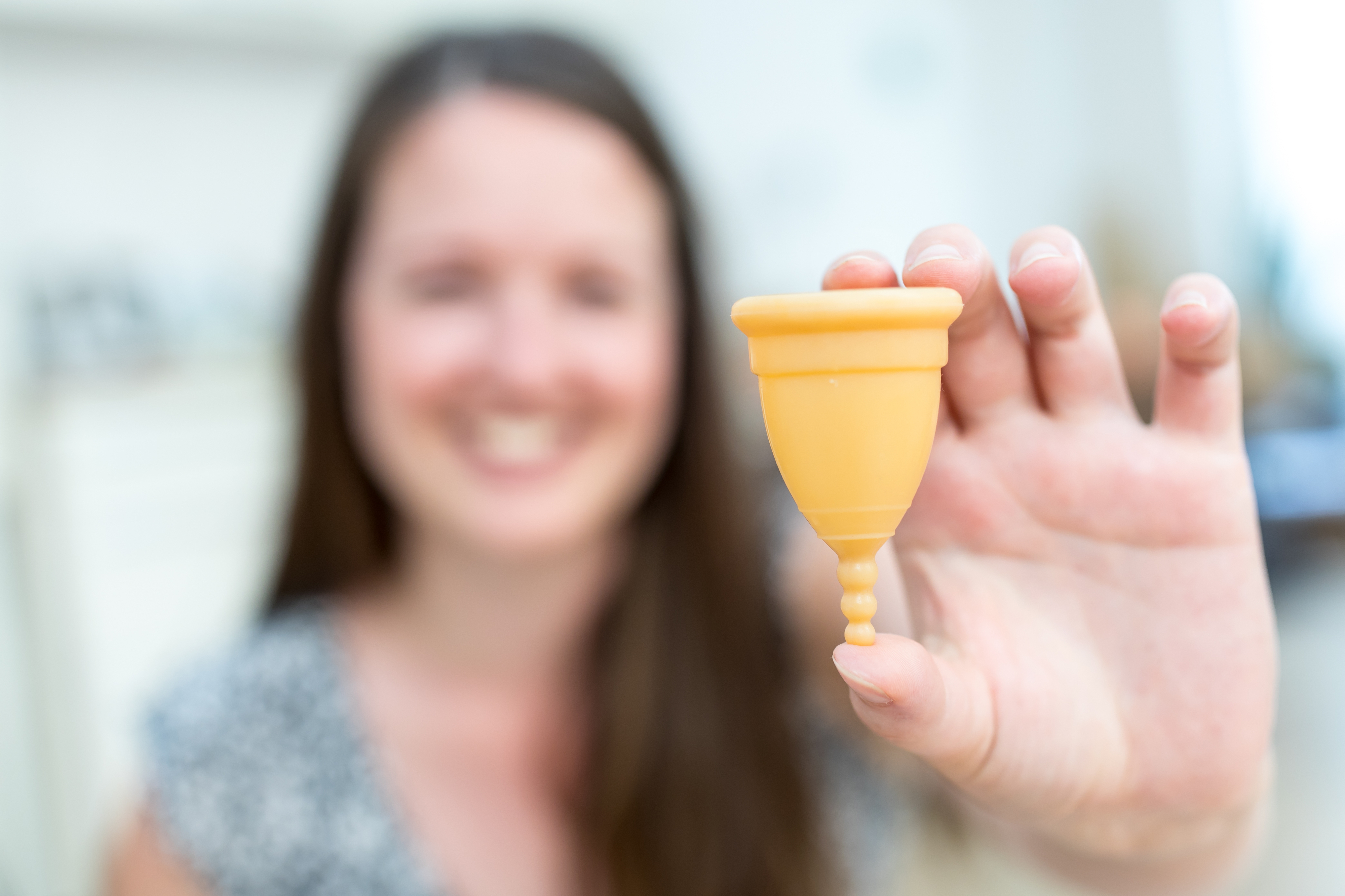 woman holding a menstrual cup
