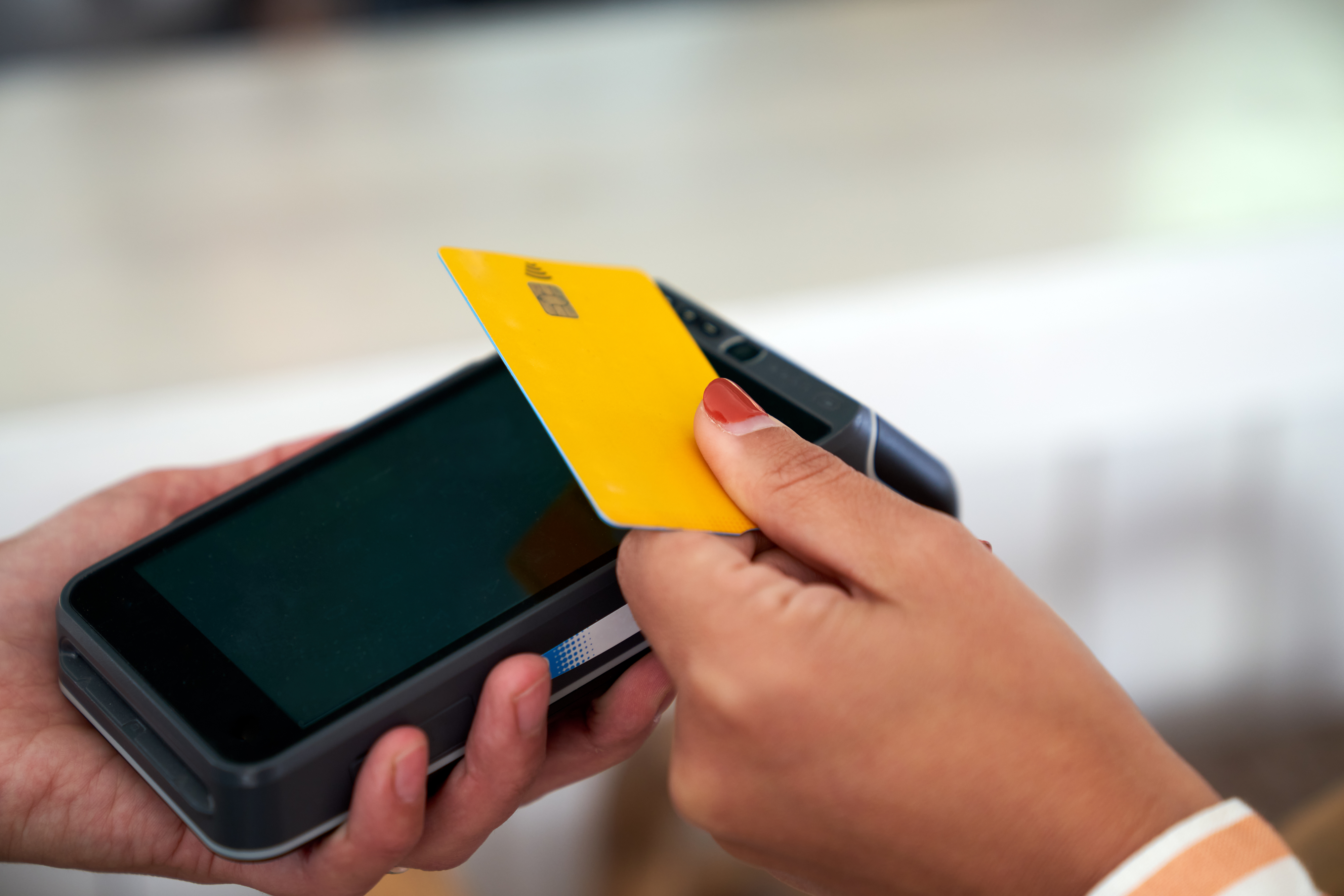 woman paying the bill in a restaurant with her credit card