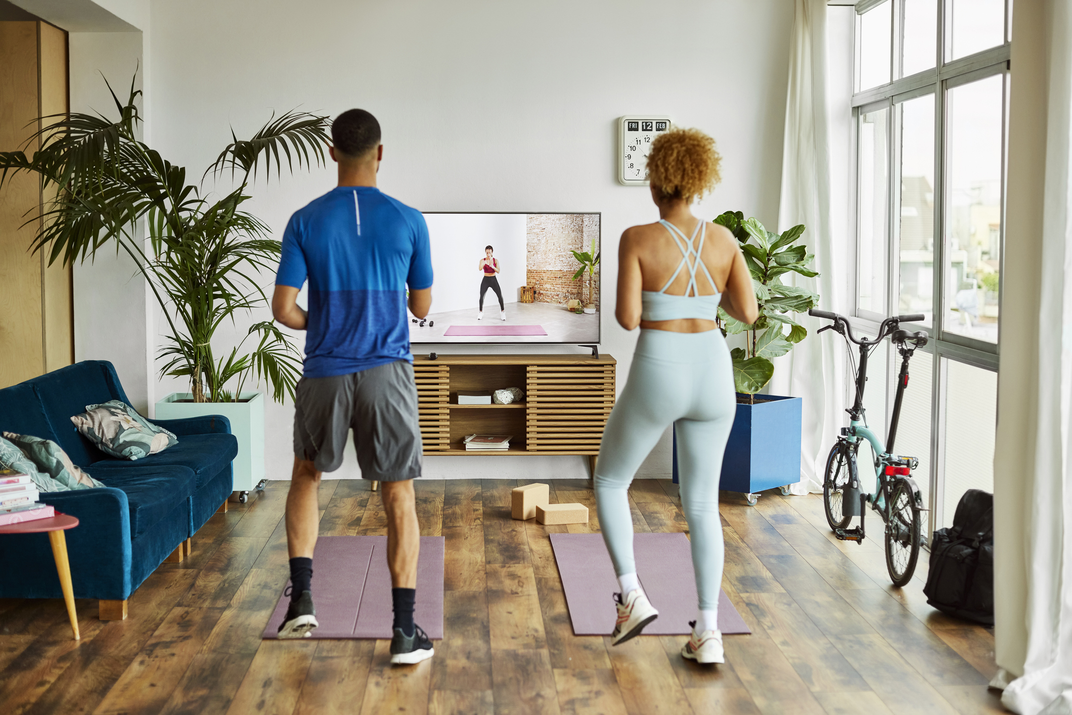 A couple working out in their living room