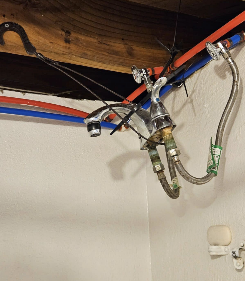 faucet tied to wires and hanging by the ceiling