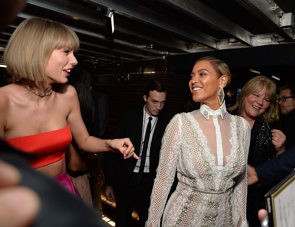 Taylor and Beyoncé smiling at each other