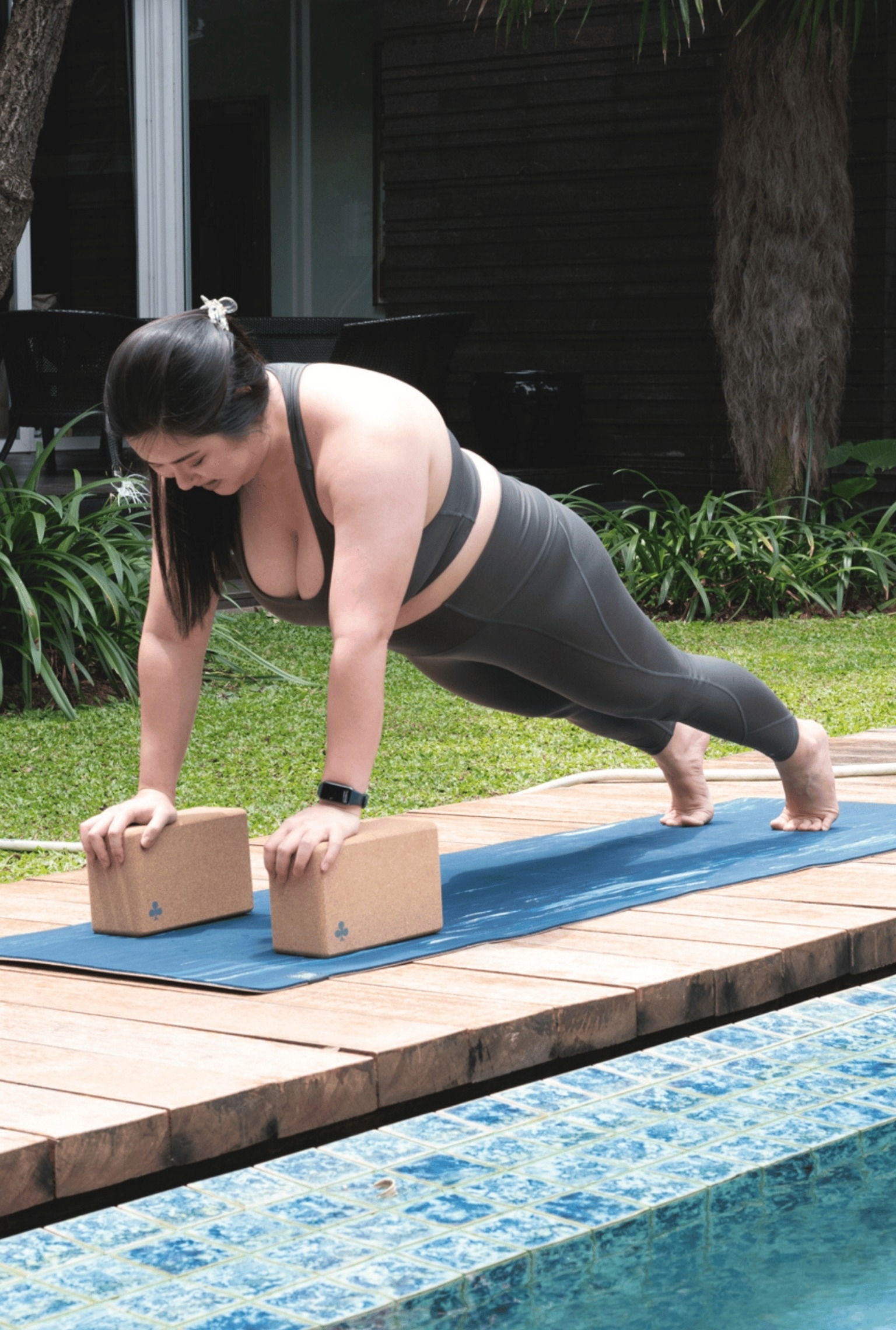 model using cork yoga blocks in a plank pose