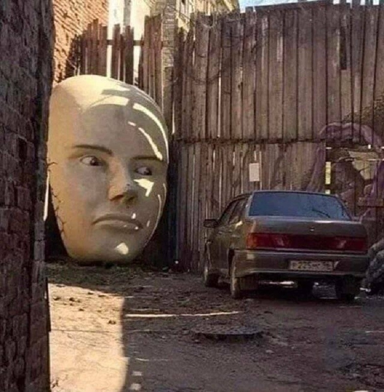 A giant face staring at a car