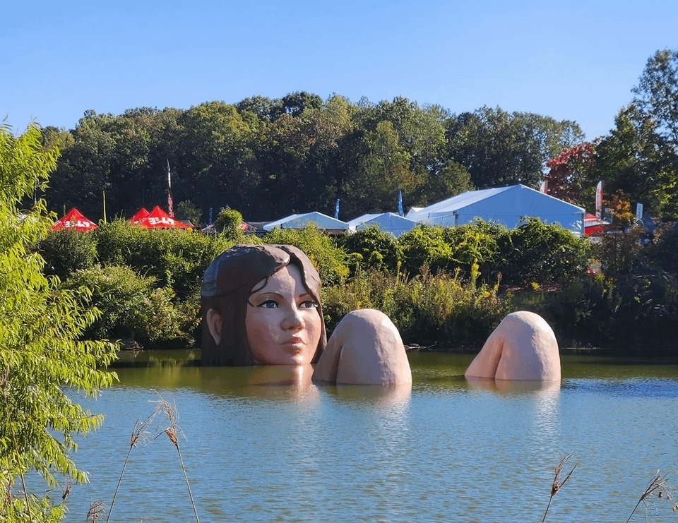 A giant woman mannequin in a lake