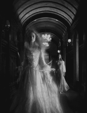 The ghost of a young woman in Victorian dress floats down a hall