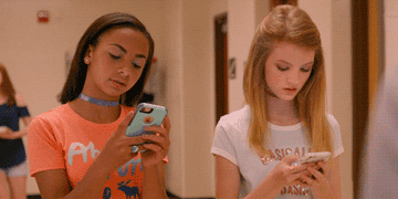 two middle school girls texting in the movie "Eighth Grade"