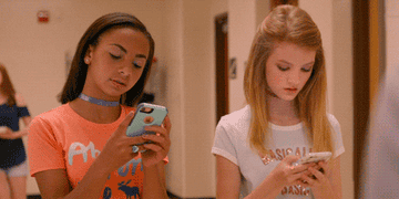 two middle school girls texting in the movie &quot;Eighth Grade&quot;