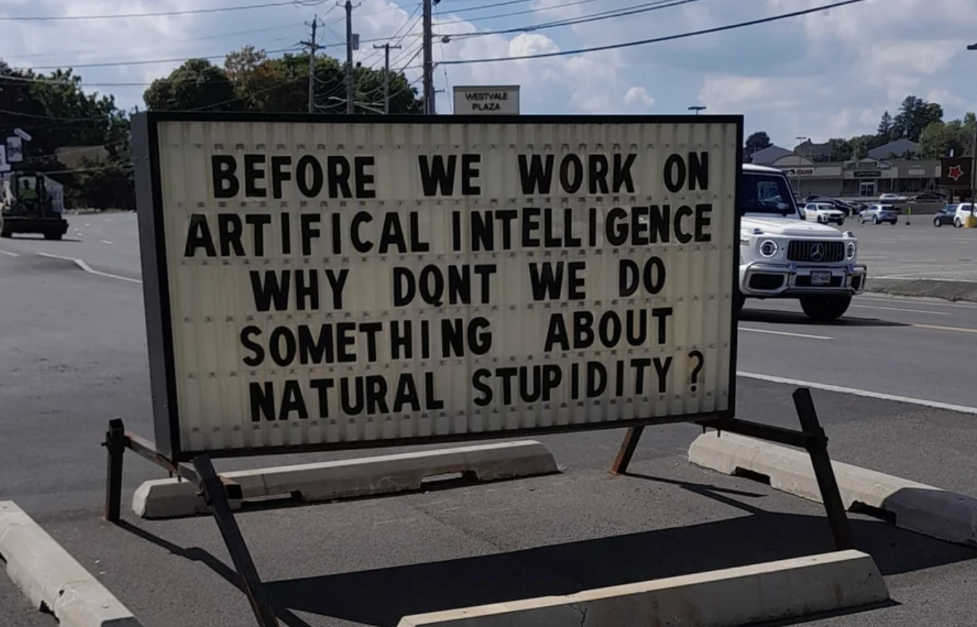 A sign outside a movie theater says &quot;before we work on artificial intelligence, why don&#x27;t we do something about natural stupidity?&quot;