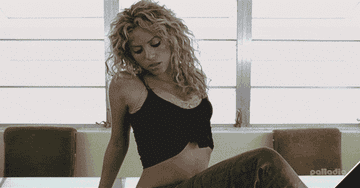 GIF of Shakira pumping her chest in the &quot;La Tortura&quot; music video