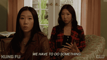 Two women sitting on a couch while one says, &quot;we have to do something&quot;