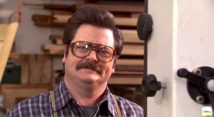 Ron Swanson from Parks and Rec smiling with safety goggles on