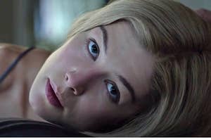 Rosamund Pike lying down and looking up as Amy in Gone Girl