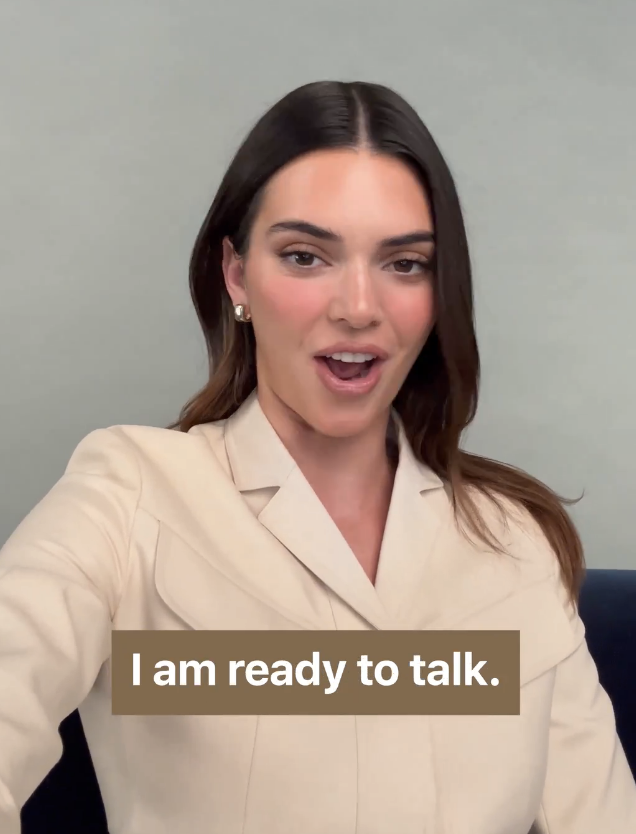 Close-up of Kendall in a suit jacket with caption &quot;I am ready to talk&quot;