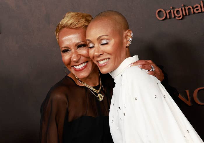 Close-up of Jada and Adrienne smiling and embracing at a media event