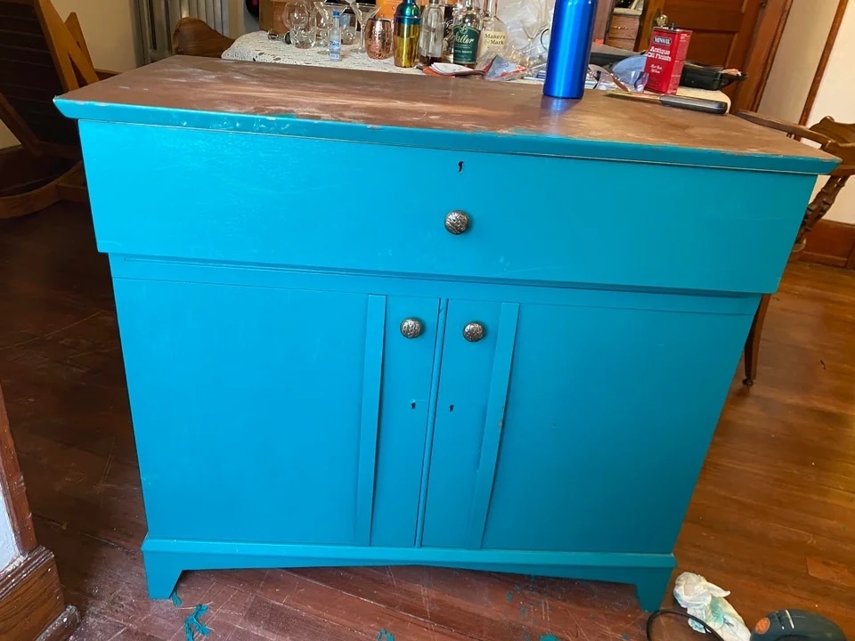 A before image a bar cabinet with blue paint